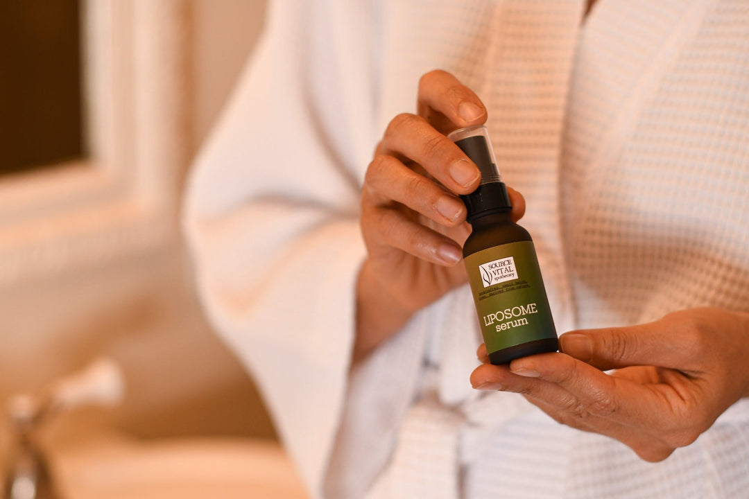 Woman holding Liposome Serum in her bathrobe