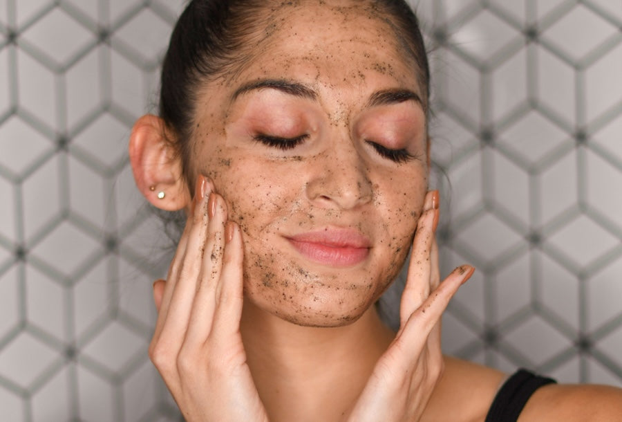 Woman exfoliating face with hands