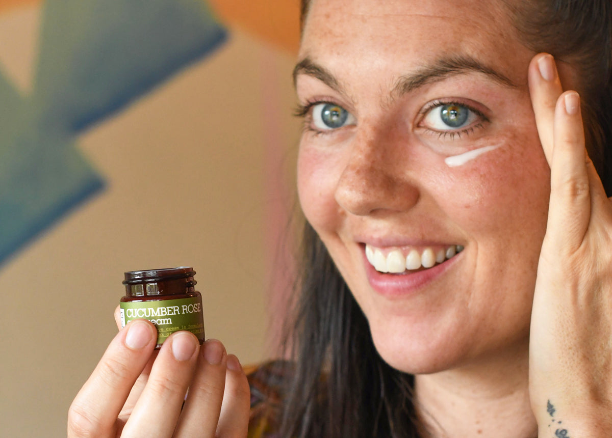 Woman applying eye cream to her undereye area with her finger