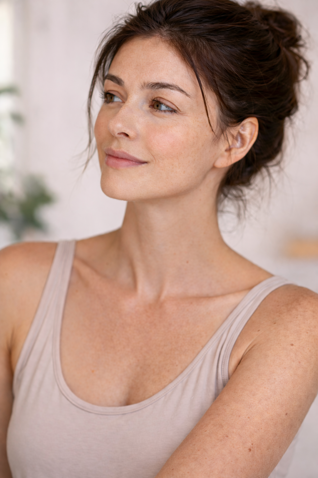 Brunette Woman with hair up with combination skin.