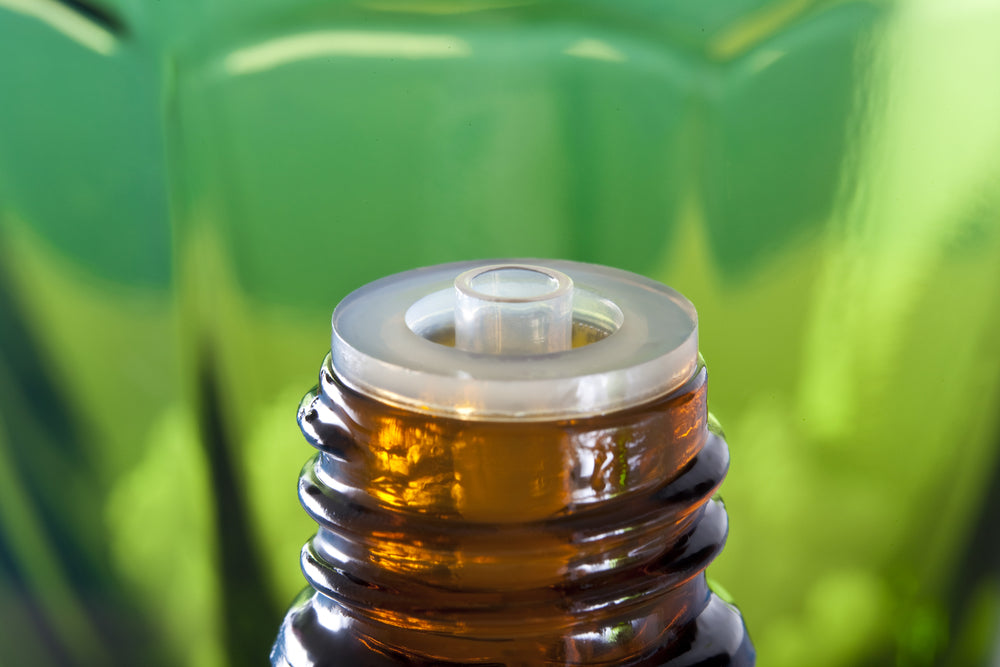 amber glass bottle top against green background