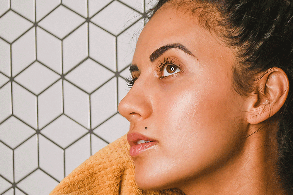 Woman patting her face dry with towel