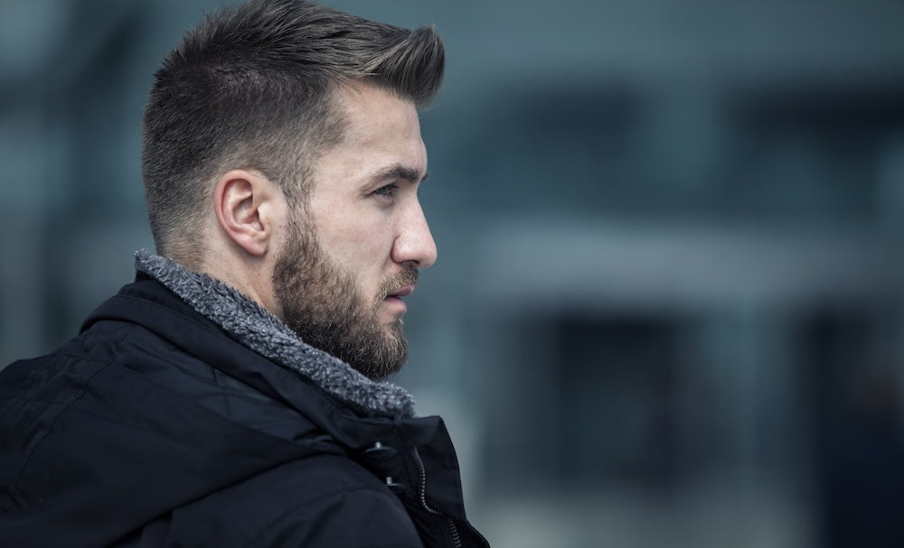 Bearded man in profile in cold weather 