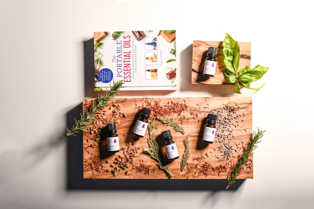 Tray of Source Vital Essential Oils with Essential OIl Book on table