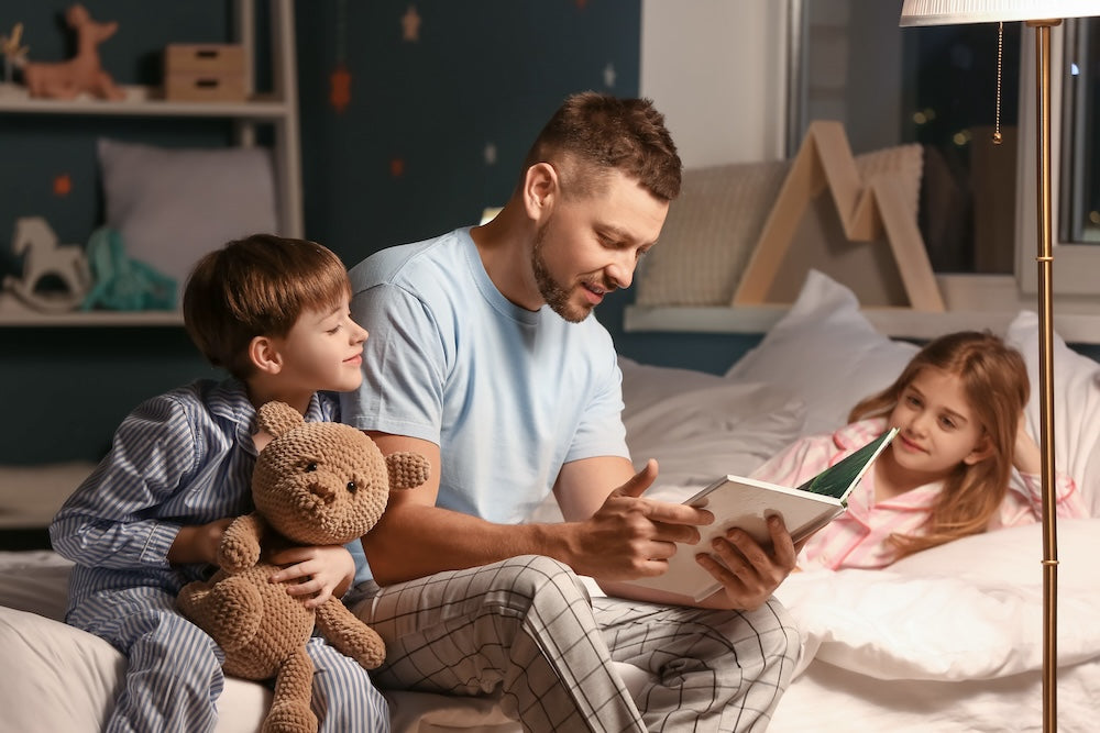Dad reading to children at bedtime