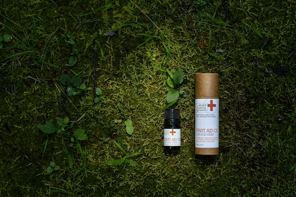 First Aid Oil in and out of packaging on mossy background