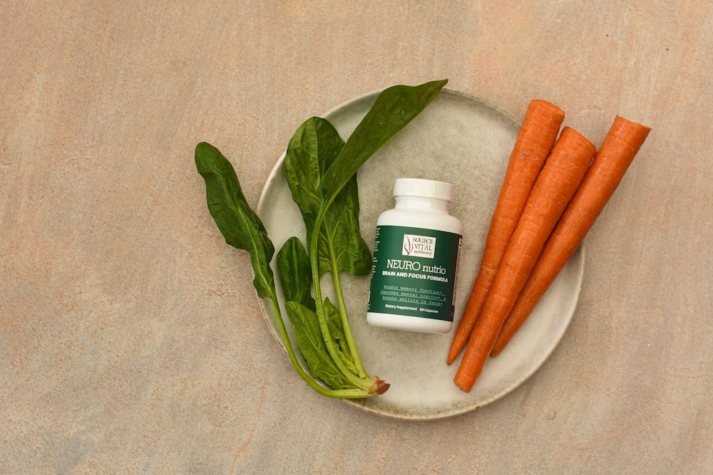 Neuro Nutrio Supplement Bottle with Carrots and greens surrounding it