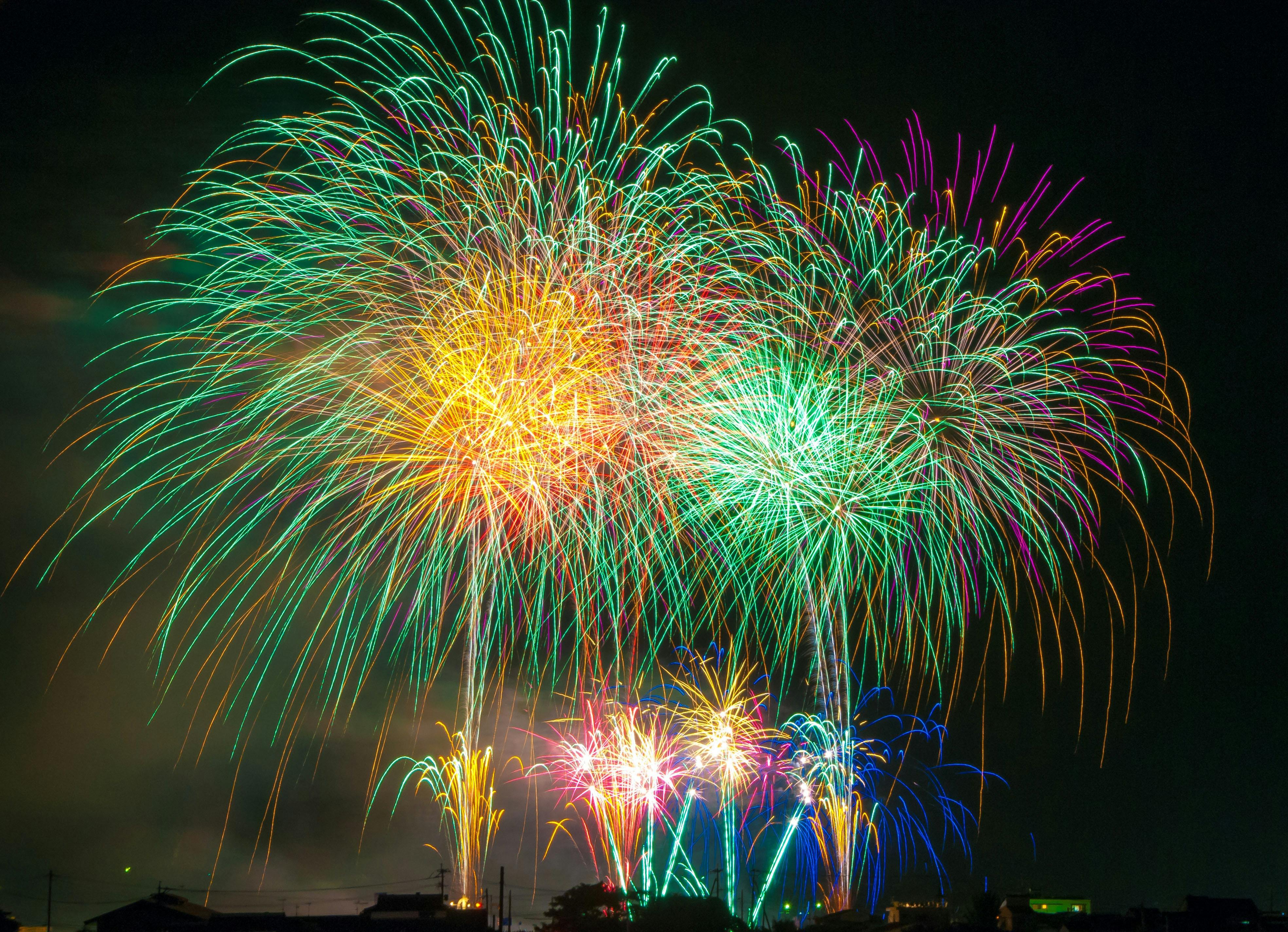 Fireworks display of green and yellow fireworks