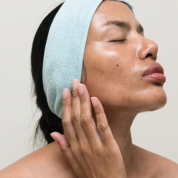 Woman moisturizing her face