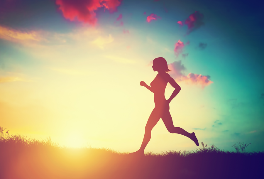 woman running against a sunset-filled sky